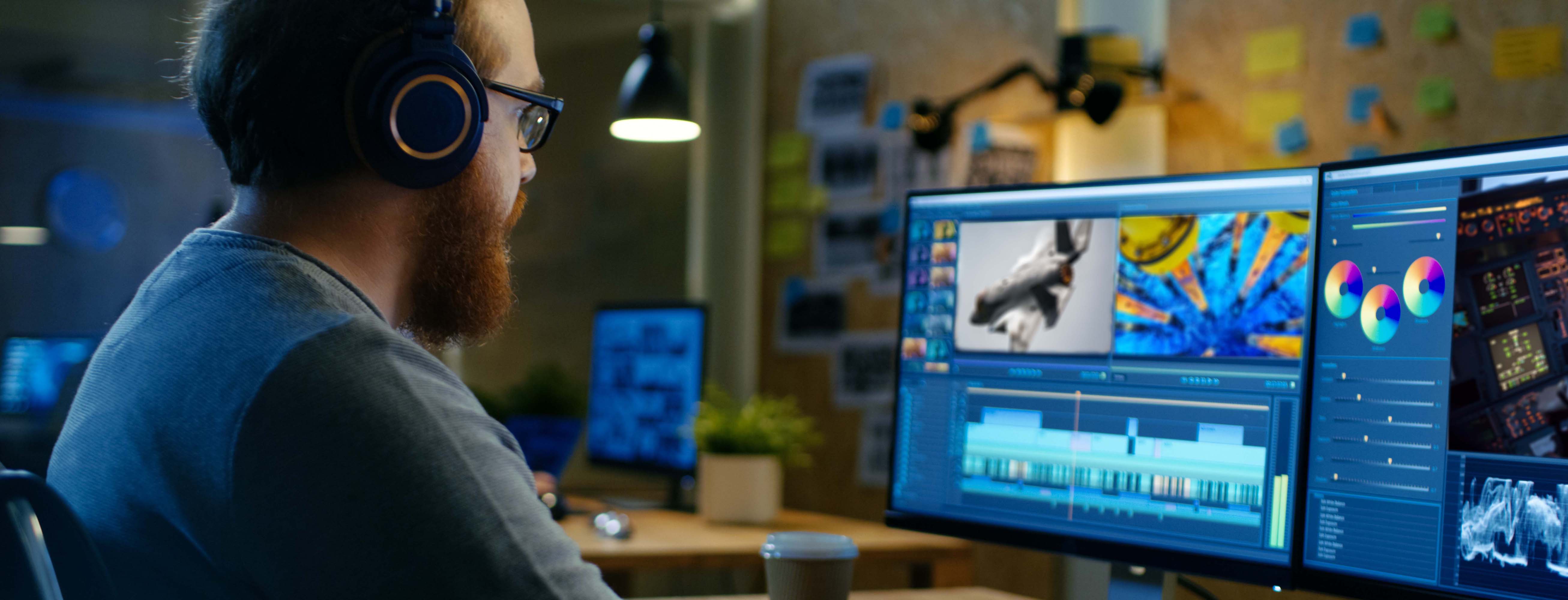 Young man working with video editing software on his computer