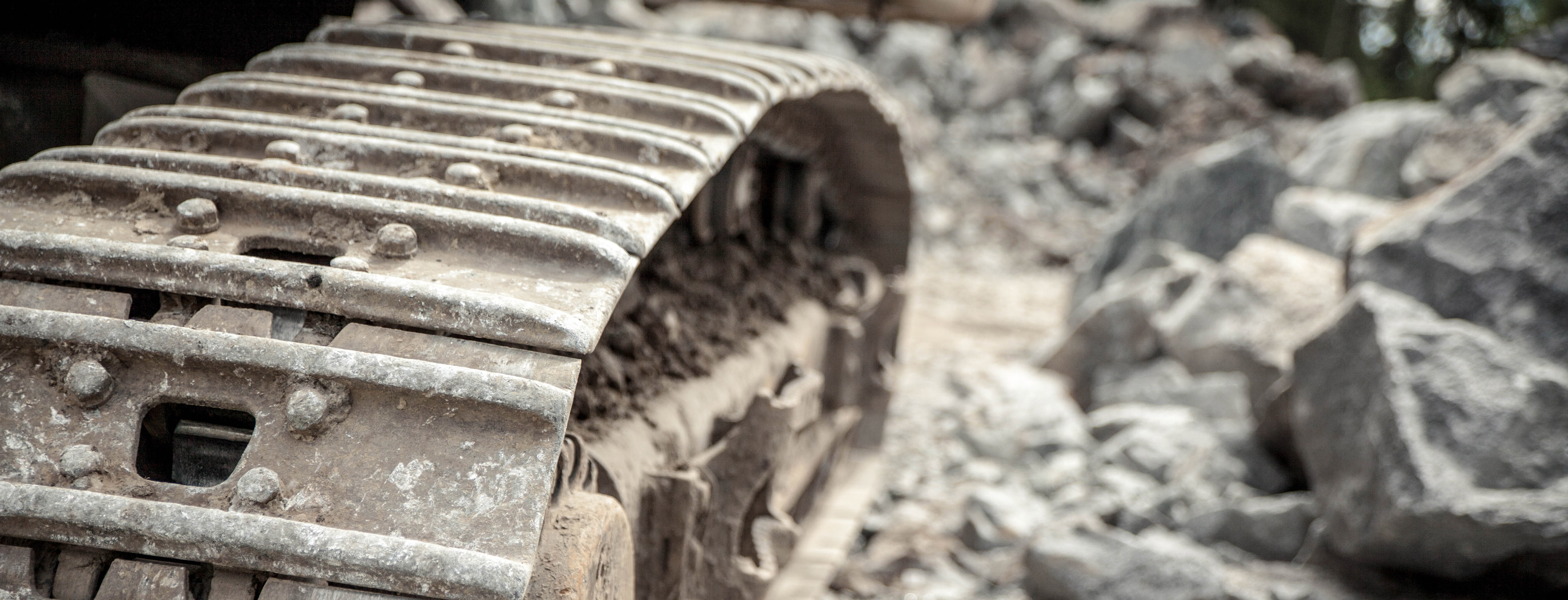 Close up on an excavator belt in ore pit.