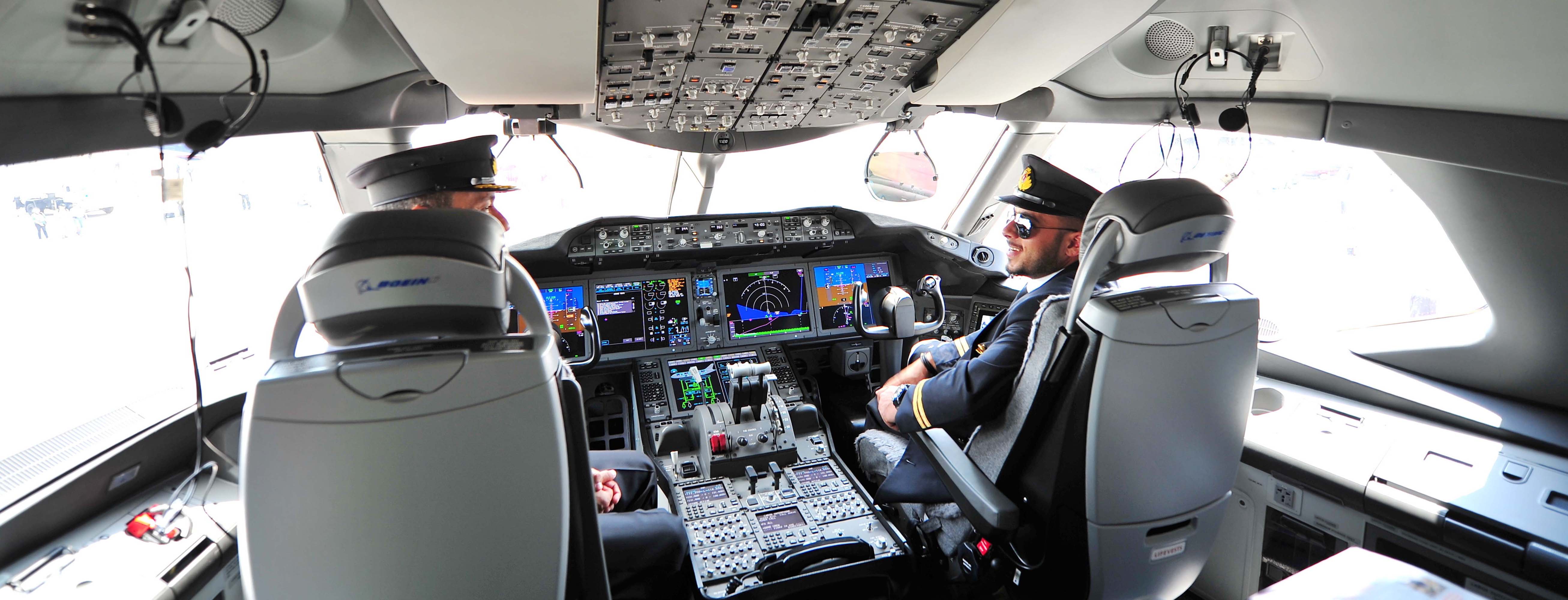 Two pilots in the cockpit talking to each other
